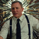 Daniel Craig as Benoit Blanc in 2019's Knives Out, with a multitude of knives in the background.